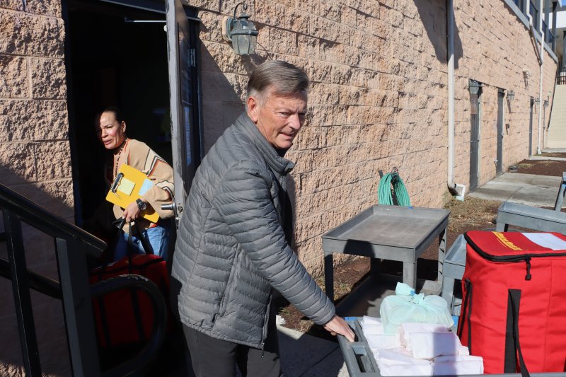 Richard Chambers takes a cart loaded with the meals for his delivery route out to his car from the Fish On kitchen. Meals on Wheels has 180 volunteers to cover routes in Lewes, Rehoboth, Milton and Milford.